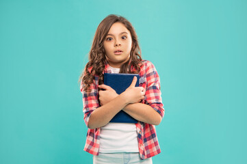 shocked pupil or student hold notebook. teen girl study with book. child holding copybooks.