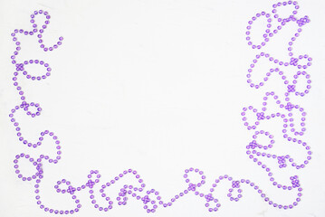 Christmas white background with frame of Christmas decorations beads. The place for the text can be used as a template.