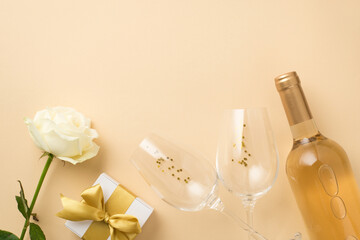 Top view photo of white rose two wineglasses with golden sequins bottle of white wine and white...