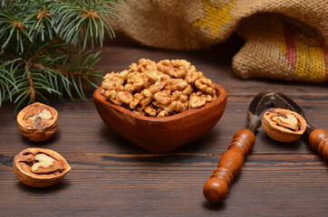 peeled walnuts kernels in a wooden bowl close-up