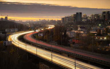 Fototapeta na wymiar Evening traffic jam on the South Bridge, Kiev Kyiv, Ukraine. View of the Chorna Hora area