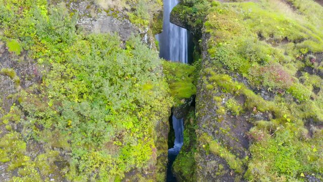 flying over the crevasse near the famous Gljufrabui waterfall in Iceland