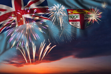 Fireworks in evening sky and flag of Fiji