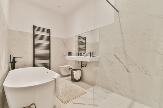 White bathroom interior with bathtub, washbasin and toilet