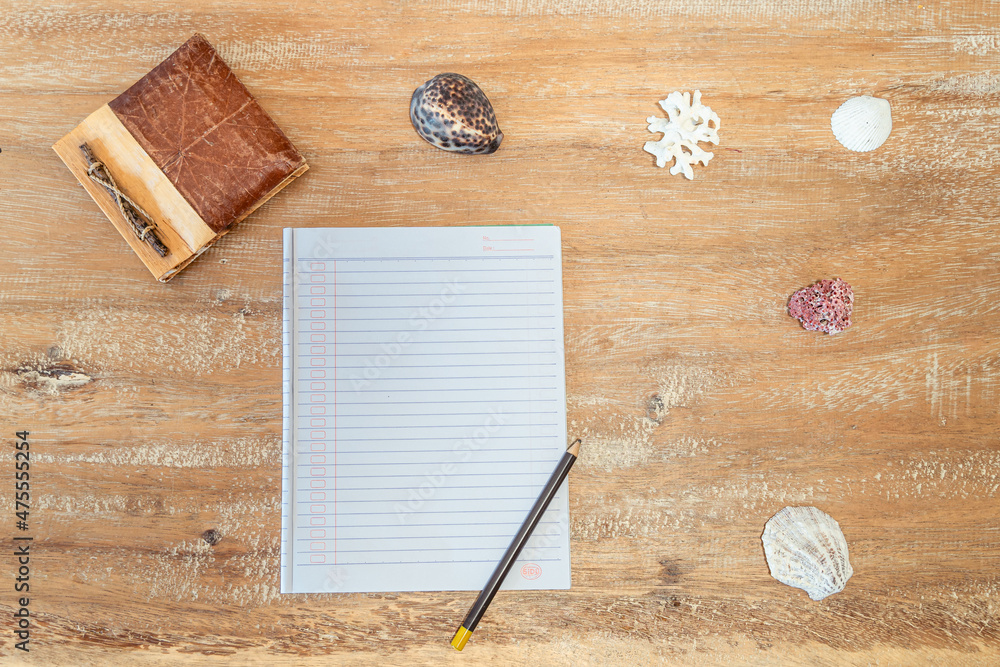 Poster top view of an open notebook with a pencil on the wooden surface