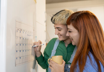 Positive lesbians marking day in calendar