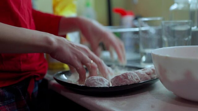 Girl in red longsleeve to cook minced meat cutlets from fresh mea