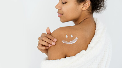 Young african american woman with a sun protection on shoulder