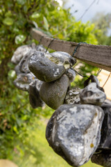 Stones or chicken gods hanging on a rope in the open air