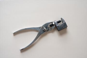 pliers and metal object with screw