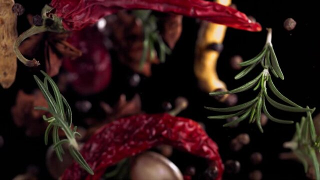 Super Slow Motion Shot of Flying Mix Spices in Black Background.