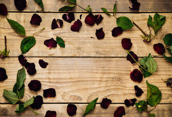 Dry rose petals on a wooden background. Herbarium and dried flowers. Texture and background.