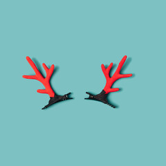 Reindeer red antlers layout on a light blue background. Christmas minimal flat lay