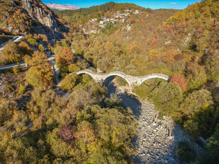 Aerial view of old Kalogeriko triple arched stone bridge on Vikos canyon, Zagorohoria, Greece,...