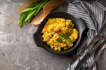 Traditional azian pilaf served in plate on gray background