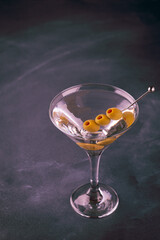 Martini cocktail on dark stone table.