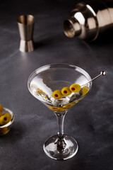 Martini cocktail on dark stone table.