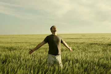 Man and field, sky landscape. Vintage color tone. Nature horizontal background with copy space.