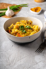 Traditional azian pilaf served in plate on gray background