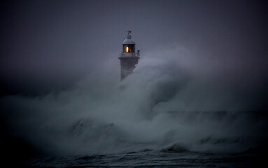 The gale force winds from Storm Arwen cause giant waves to batter the lighthouse and north pier guarding the mouth of the Tyne in Tynemouth, England
