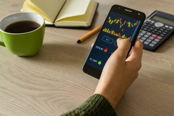 Young man reviewing and investing in the stock market with technical indicator tools on his...