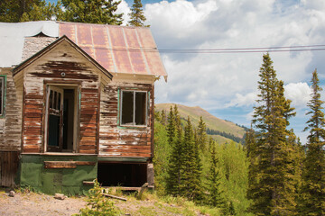 Old abandoned wooden home at a ghost town in the mountains 