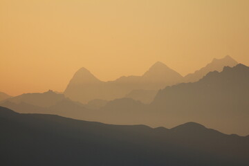 Outlines of mountain ranges in the golden morning hour.