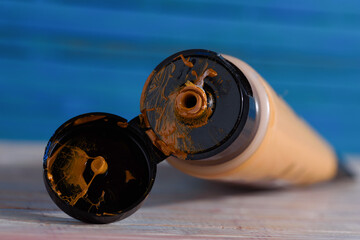 Open tube of yellow ocher acrylic paint.
