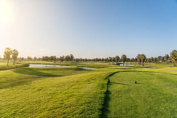 Modern golf courses for tourists with clear ponds and palm trees for relaxation and golf. Albufeira, Algarve Sunny day