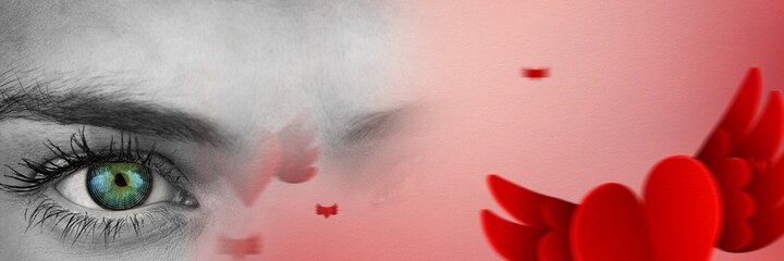 Composite image of close up of a female eye and red heart with wings icons