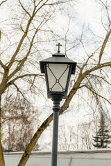 Fototapeta na wymiar Metal street lamp with cross retro style outdoors object colored