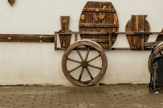an old wagon wheel a wooden barrel for a wine