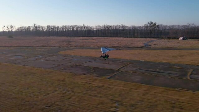 Motorized hang glider trike take off from the airfield