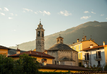 Fototapeta na wymiar View on Tremezzo : Old christian church in sunset sunbeams lake. Coast of Como in Christmas week