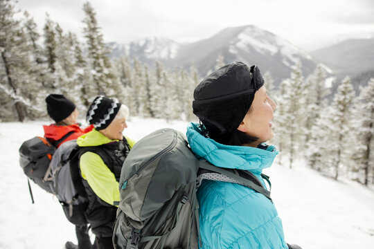 Friends Stopping To Look At View On Winter Hike