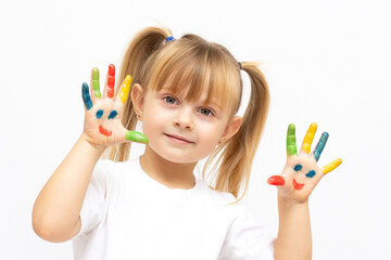 beautiful little girl with her hands in the paint