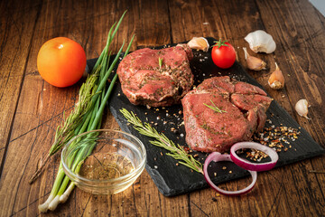 a piece of meat and vegetables on a black slate Board