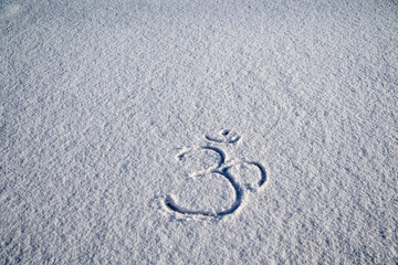 An inscription on the snow. Buddhist sign for meditation. Om shanti. Meditation, achieving Zen, a...