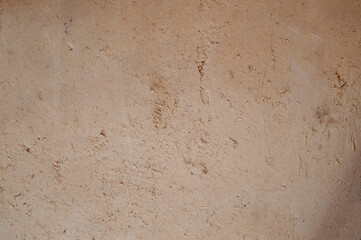 An ancient method of plastering with clay. Old clay wall. Last century. Old plaster background.