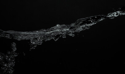 Soda water bubble splashing and floating drop. Represent sparkling and refreshing. Close up soda water bubbles floating up to top of water surface on black BG. Splashing carbonate drinks refreshing.