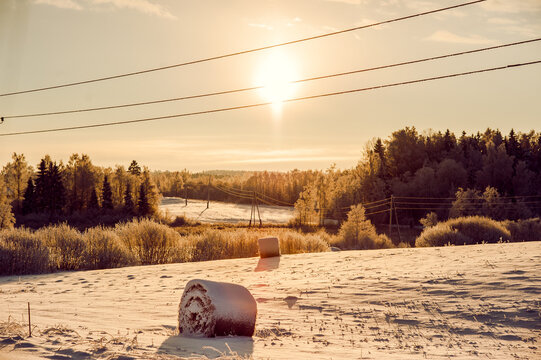 Scenic view of haystacks, winter sunset in the countryside
