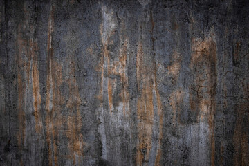 Abstract, dark wall texture background. Grey and orange color. Low key, creative, scary, moody wall. Smudges, scrathes, drips, drops. Old, aged, weathered, cracked concrete surface structure backdrop