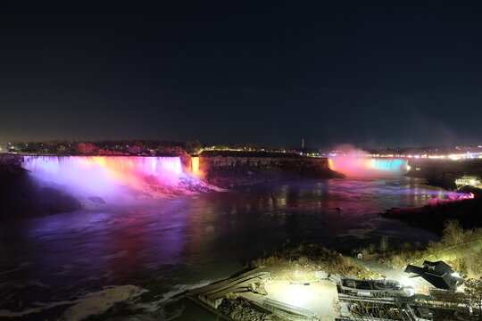 American Falls, Bridal Veil Falls, Niagara Falls at night, with light pointing at it © Serg