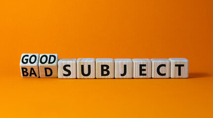 Good or bad subject symbol. Turned wooden cubes and changed the word bad subject to good subject. Beautiful orange table, orange background. Business, good or bad subject concept. Copy space.