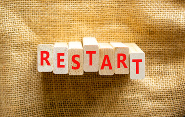 Restart and start symbol. The concept word Restart on wooden blocks. Beautiful canvas background, copy space. Business restart and start concept.