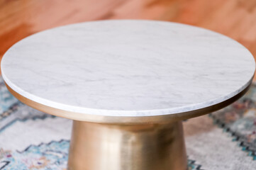 Modern style coffee table with brass metal base, marble top and wooden background. Round coffee table. Modern - Image
