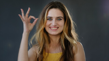Female portrait successful feminist woman millennial girl lady blonde model shows ok sign symbol...