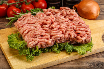 Raw pork minced meat over board