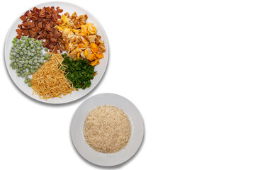 Arroz biro-biro ingredients, is a typical Brazilian dish to accompany or as a main course. Parsley, potato sticks, peas, egg, and bacon