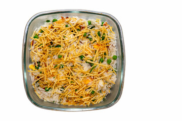 Biro-biro rice is a typical Brazilian dish to accompany or as a main course. Parsley, potato sticks, peas, egg, and bacon. Isolated in top view